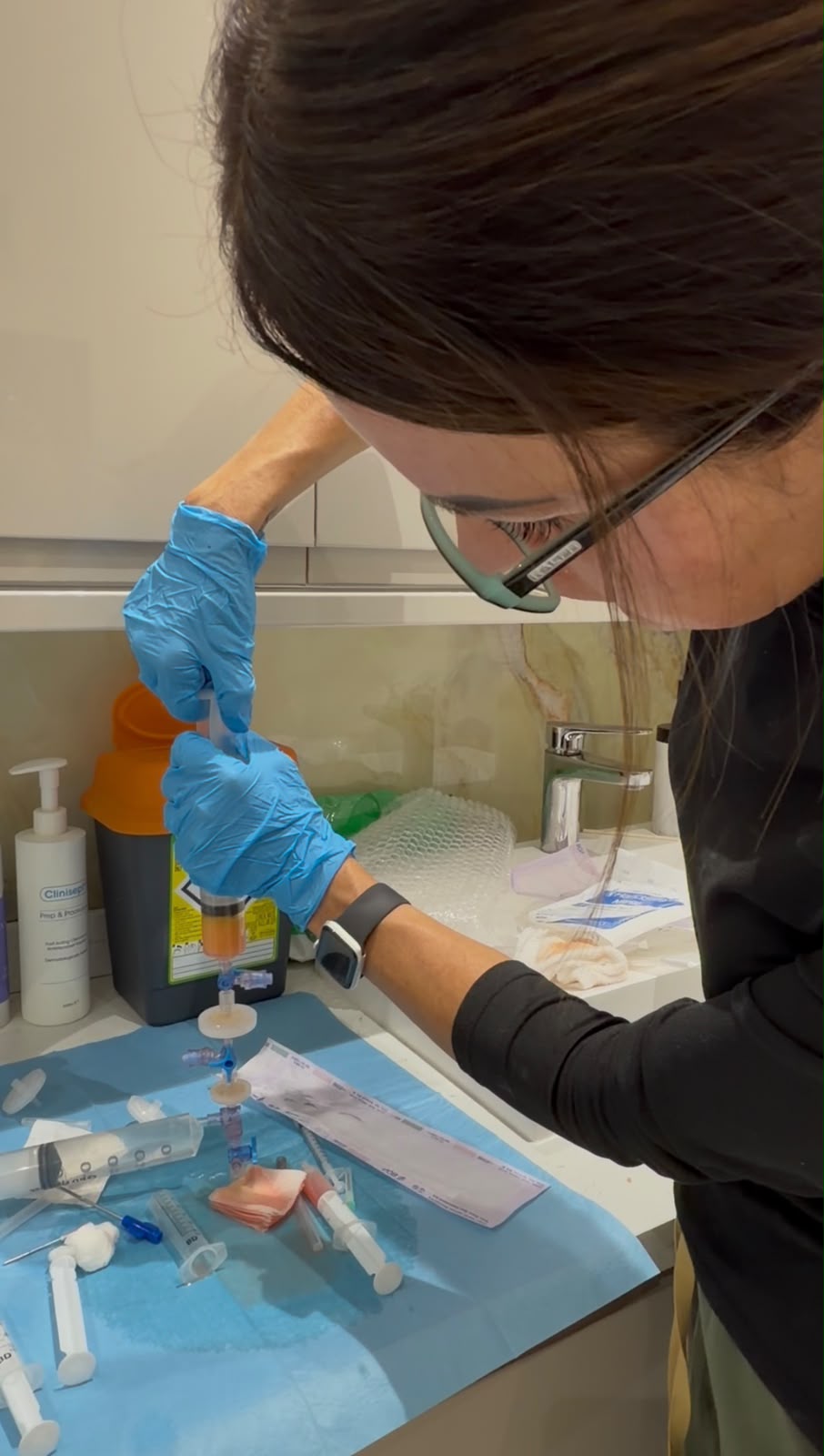 Becky holding a syringe of purified fat ready for transfer